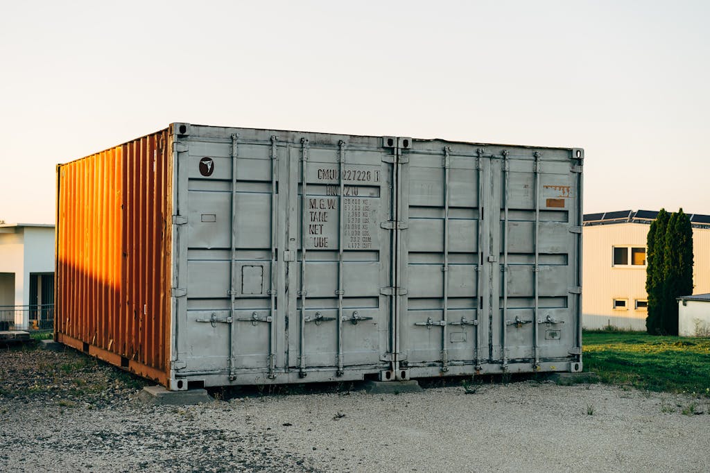 Two shipping containers sitting in front of a building